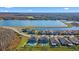 Aerial view of homes with backyard pools near a lake and green spaces, in a well-maintained community at 18329 Roseate Dr, Lutz, FL 33558