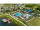 An aerial view showcases community pool, lakeside dock, and other community amenities at 18329 Roseate Dr, Lutz, FL 33558