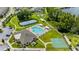 An aerial view of community amenities, including a pool, tennis court, and playground at 18329 Roseate Dr, Lutz, FL 33558