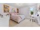 Light and airy bedroom with a window, desk and a view to the outdoors at 18329 Roseate Dr, Lutz, FL 33558