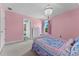 Lovely pink bedroom with a chandelier, a view of a window, and an ensuite bathroom at 18329 Roseate Dr, Lutz, FL 33558