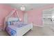 Charming pink bedroom with a chandelier, canopied bed and access to the upstairs landing at 18329 Roseate Dr, Lutz, FL 33558