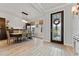 Bright dining area featuring wood-look tile floors, modern lighting, and elegant decor at 18329 Roseate Dr, Lutz, FL 33558