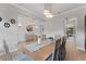 Elegant dining room with wood-look floors, modern lighting, and views into other rooms at 18329 Roseate Dr, Lutz, FL 33558