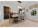 Stylish dining room with wood-look tile flooring, elegant chandelier, and modern decor at 18329 Roseate Dr, Lutz, FL 33558