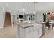 Bright kitchen island featuring barstool seating and stainless steel appliances at 18329 Roseate Dr, Lutz, FL 33558