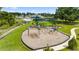 A playground with swings and slides with covered seating and walking paths near community amenities at 18329 Roseate Dr, Lutz, FL 33558