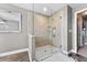 Luxurious walk-in shower with tile surround and frameless glass doors at 18329 Roseate Dr, Lutz, FL 33558