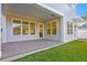 The covered back porch has brick pavers and a view into the house through an open doorway at 243 28Th N Ave, St Petersburg, FL 33704