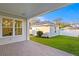 Inviting back porch features brick pavers and a view of the detached garage and landscaped backyard at 243 28Th N Ave, St Petersburg, FL 33704