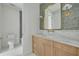 Bathroom with marble countertop vanity, brass fixtures and gray tiled shower/tub at 243 28Th N Ave, St Petersburg, FL 33704