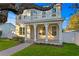 Charming two-story home featuring a welcoming front porch and upper balcony, complemented by a well-manicured lawn at 243 28Th N Ave, St Petersburg, FL 33704