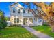 Inviting two-story home with a classic front porch, a charming upper balcony, and lush green lawn at 243 28Th N Ave, St Petersburg, FL 33704