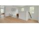 Upstairs hallway with light-colored hardwood floors and multiple seating areas at 243 28Th N Ave, St Petersburg, FL 33704