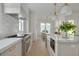 Spacious kitchen featuring marble countertops, stainless steel appliances, and stylish lighting at 243 28Th N Ave, St Petersburg, FL 33704