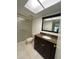 Bathroom featuring a vanity, toilet, and shower-tub combination, illuminated by a skylight at 2591 Countryside Blvd # 5203, Clearwater, FL 33761