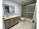 Well-lit bathroom with a framed mirror, vanity with storage, and a shower-tub combo at 2591 Countryside Blvd # 5203, Clearwater, FL 33761