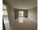 Neutral bedroom with tile flooring leads to an outdoor balcony space at 2591 Countryside Blvd # 5203, Clearwater, FL 33761