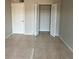 Bedroom featuring tile flooring, a closet, and a white door, offering a clean and functional space at 2591 Countryside Blvd # 5203, Clearwater, FL 33761