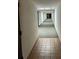 Long hallway featuring tile flooring and overhead lighting at 2591 Countryside Blvd # 5203, Clearwater, FL 33761