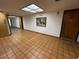 Well-lit hallway with tiled flooring, art, and a view down the hall at 2591 Countryside Blvd # 5203, Clearwater, FL 33761