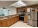 Bright kitchen with stainless steel appliances and tiled backsplash at 2591 Countryside Blvd # 5203, Clearwater, FL 33761