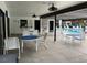 Poolside dining area with tables, chairs, and shaded pergola at 2591 Countryside Blvd # 5203, Clearwater, FL 33761