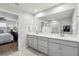 Bathroom featuring double sinks, quartz countertops and tiled floors at 25993 Woven Wicker Bnd, Lutz, FL 33559