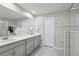 Bright bathroom featuring double sinks, quartz countertops and tiled floors at 25993 Woven Wicker Bnd, Lutz, FL 33559