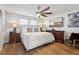 Large bedroom with a ceiling fan, wood floors, and modern decor at 25993 Woven Wicker Bnd, Lutz, FL 33559