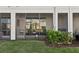 View of screened patio with outdoor seating and manicured shrubbery at 25993 Woven Wicker Bnd, Lutz, FL 33559