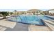 Community pool with zero entry, splash fountain and pool side lounge chairs at 25993 Woven Wicker Bnd, Lutz, FL 33559