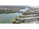 Aerial view of waterfront homes, a canal, bridge, and lush greenery in a coastal community at 330 6Th Ave, Indian Rocks Beach, FL 33785