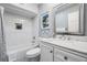 Bright bathroom with subway tile surround the tub, updated vanity and decorative mirror at 330 6Th Ave, Indian Rocks Beach, FL 33785