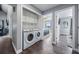 Convenient laundry room with modern washer and dryer, adjacent to the Primary bedroom at 330 6Th Ave, Indian Rocks Beach, FL 33785