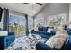 Bright living room with blue furniture, glass table, patterned rug, and balcony access at 330 6Th Ave, Indian Rocks Beach, FL 33785