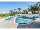 Sparkling pool surrounded by sun loungers, palm trees, and lush landscaping at 330 6Th Ave, Indian Rocks Beach, FL 33785