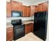 Spacious kitchen features stainless steel refrigerator, range, and microwave at 3808 Cat Mint St, Tampa, FL 33619