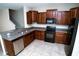 Open kitchen featuring stainless steel dishwasher, granite countertops, and cherry wood cabinets at 3808 Cat Mint St, Tampa, FL 33619