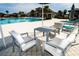 Comfortable outdoor seating arrangement by the pool area, perfect for relaxing with friends and Gathering at 3808 Cat Mint St, Tampa, FL 33619