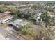 An aerial view of the house with surrounding trees and neighborhood, plus a long vehicle at 3817 N 54Th St, Tampa, FL 33619