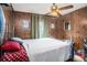 Comfortable bedroom with wood paneled walls and a bright ceiling fan at 3817 N 54Th St, Tampa, FL 33619