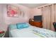 Cozy bedroom features pink walls and a comfortable bed with floral accents at 3817 N 54Th St, Tampa, FL 33619