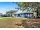 Charming one-story home with blue exterior and well-manicured front lawn at 39035 Citadel Cir, Zephyrhills, FL 33542