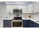 Bright kitchen showcasing stainless steel appliances and white subway tile backsplash at 39035 Citadel Cir, Zephyrhills, FL 33542