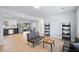 Bright living room leading into kitchen with stainless steel refrigerator and dining area with slider door at 39035 Citadel Cir, Zephyrhills, FL 33542