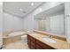 Bright bathroom featuring a double vanity, large mirror, and soaking tub at 449 S 12Th St # 1105, Tampa, FL 33602