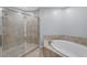 This bright bathroom features a glass shower and a separate soaking tub at 449 S 12Th St # 1105, Tampa, FL 33602