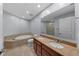 This bright bathroom features double sinks, a soaking tub and a large mirror at 449 S 12Th St # 1105, Tampa, FL 33602