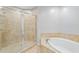 Bright bathroom with glass shower enclosure, tiled surround, and separate soaking tub at 449 S 12Th St # 1105, Tampa, FL 33602